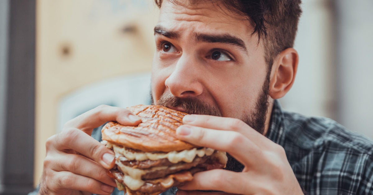 https://post.greatist.com/wp-content/uploads/sites/2/2019/04/Guye-Eating-Burger-1200x628.jpg