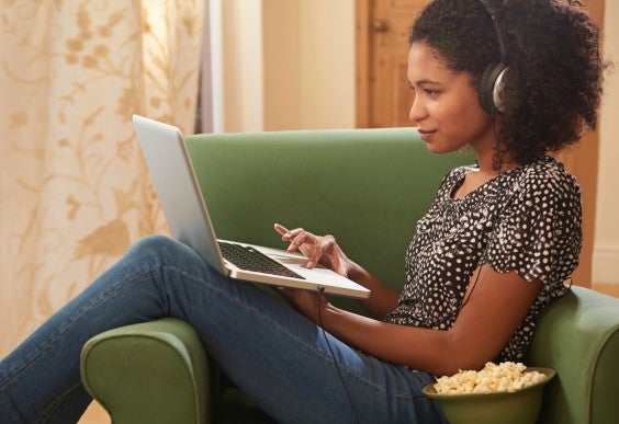 Woman on Laptop Eating Popcorn