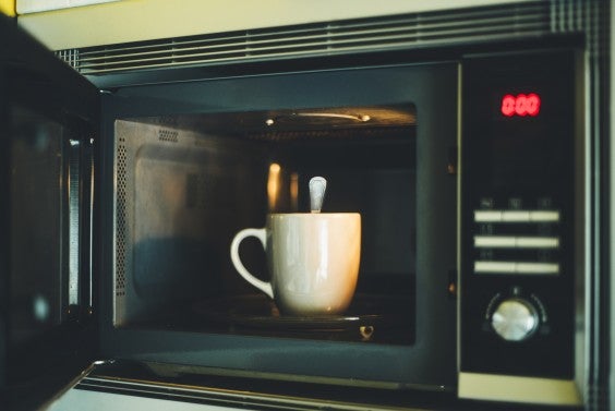 Mug and spoon in a microwave