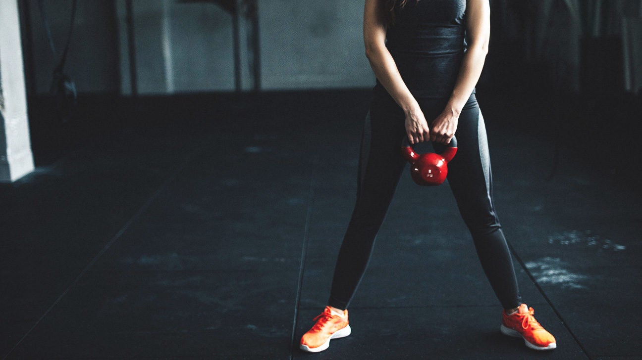 exerciser holding a kettlebell