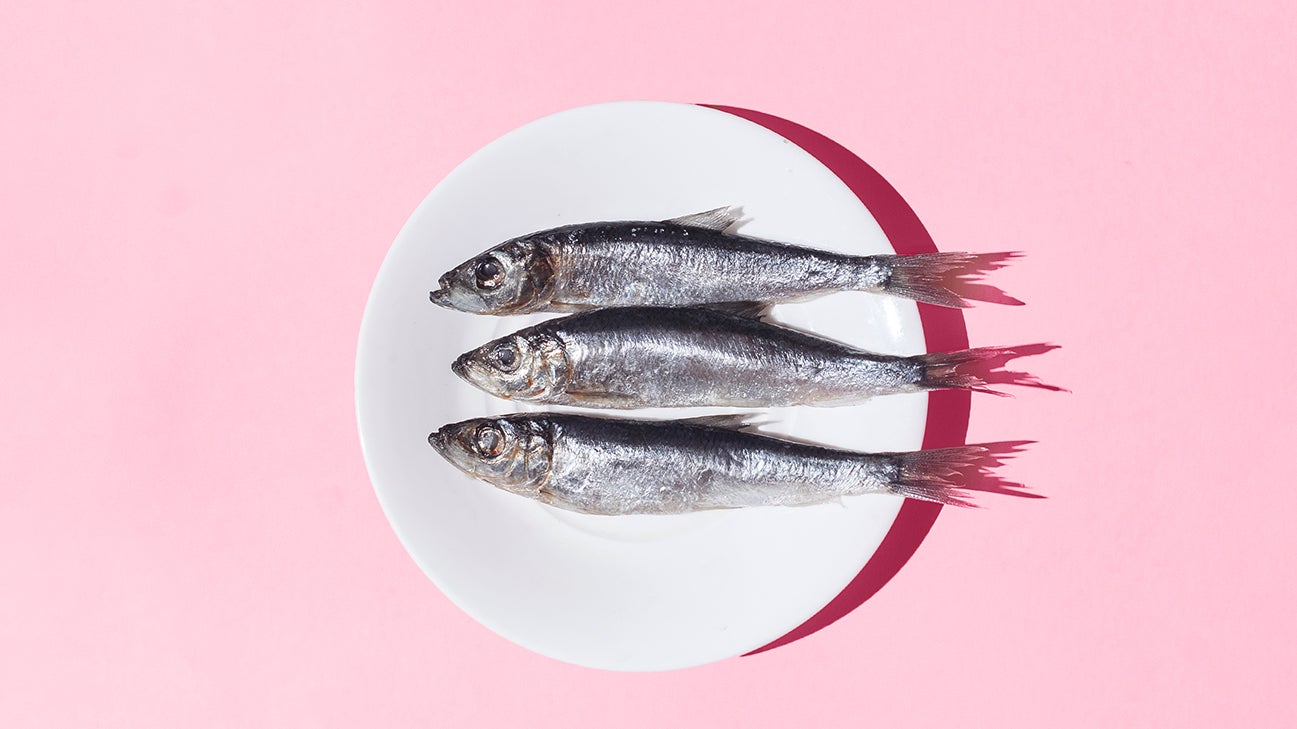 three small whole fishes on a plate