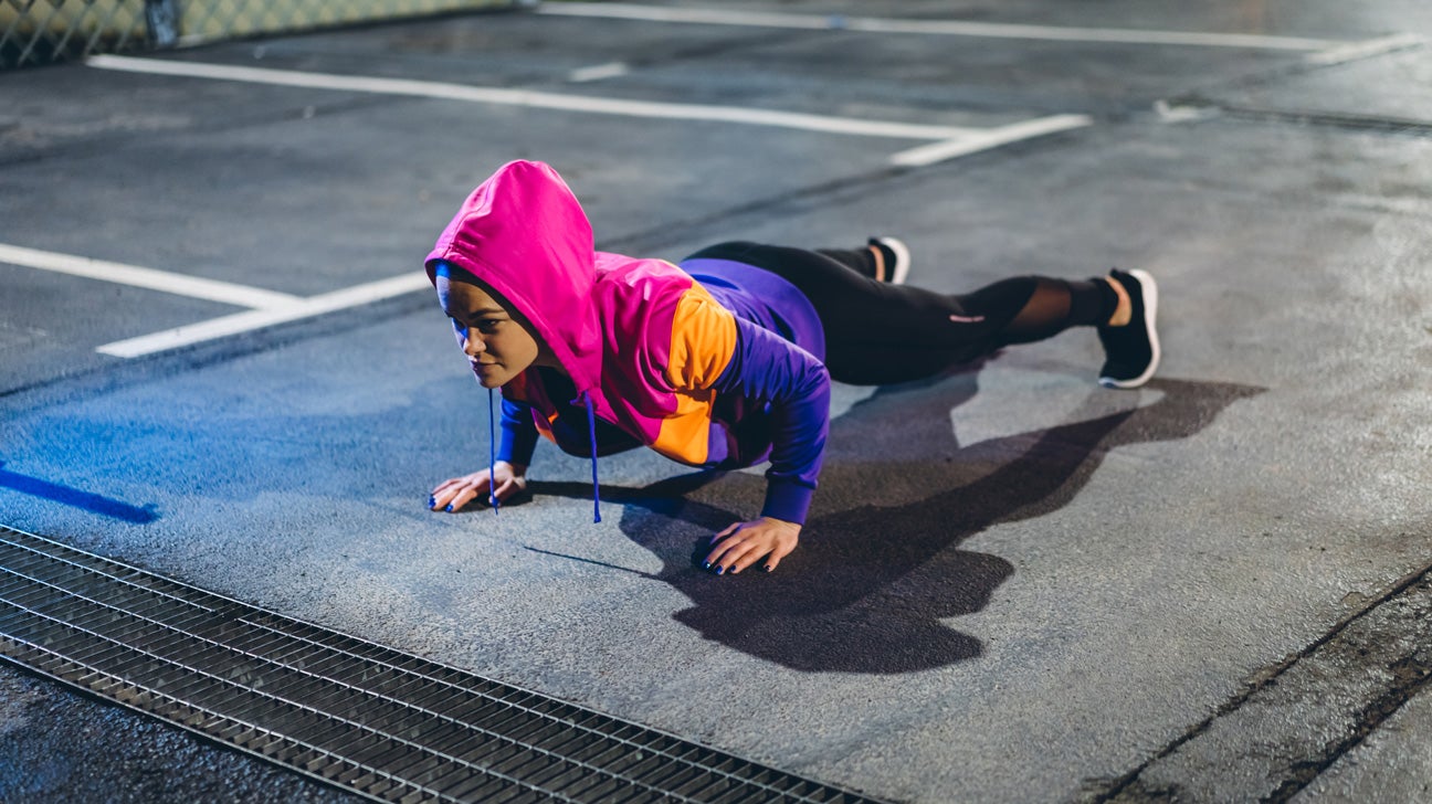 young woman holding a plank exercise 