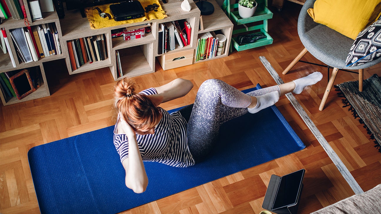 Woman performs bicycle crunch for core and cardio header