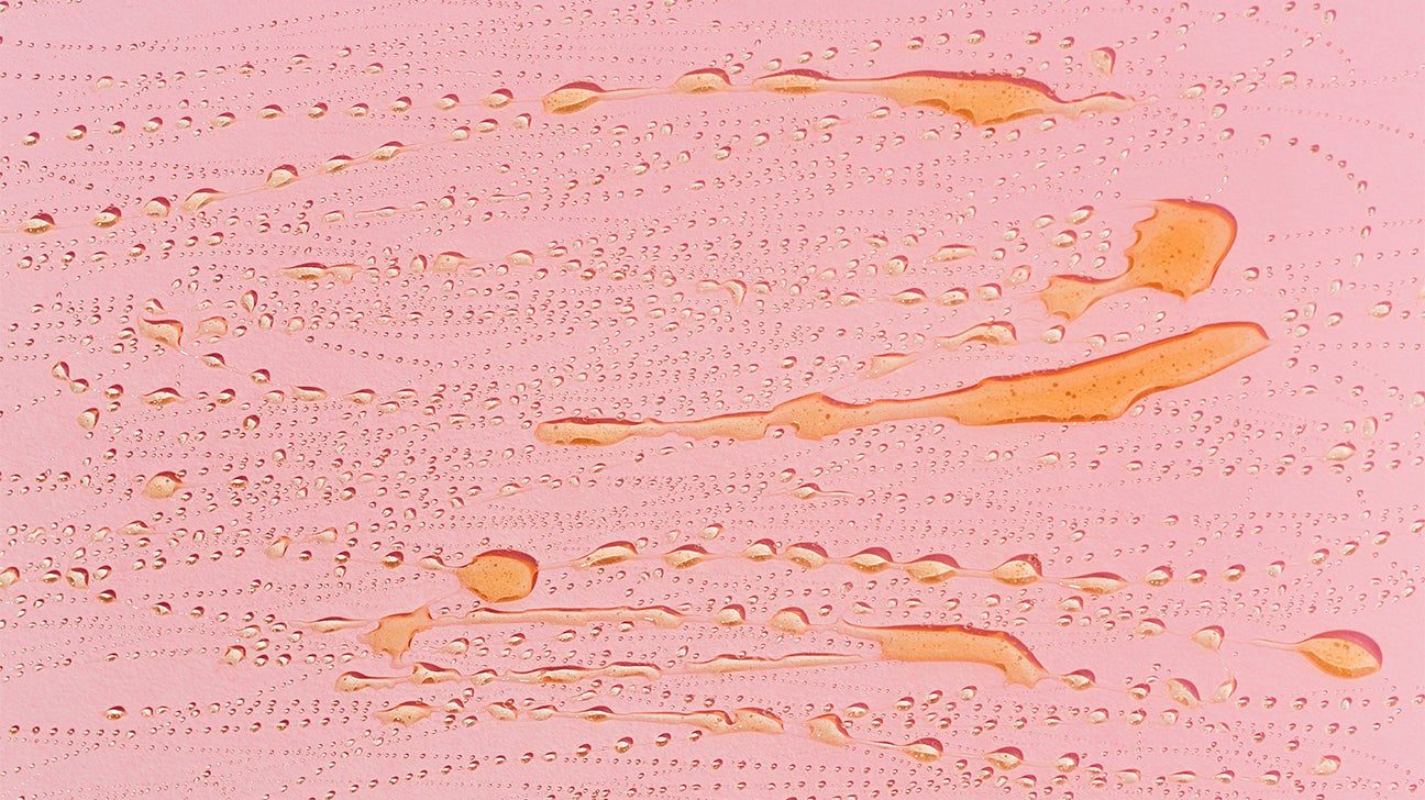 honey smeared on pink background