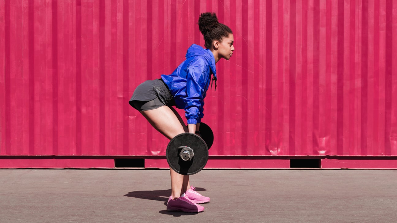 Woman learning How to Do Deadlifts