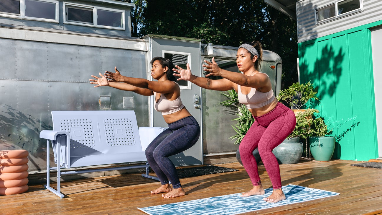 two women doing yoga while traveling