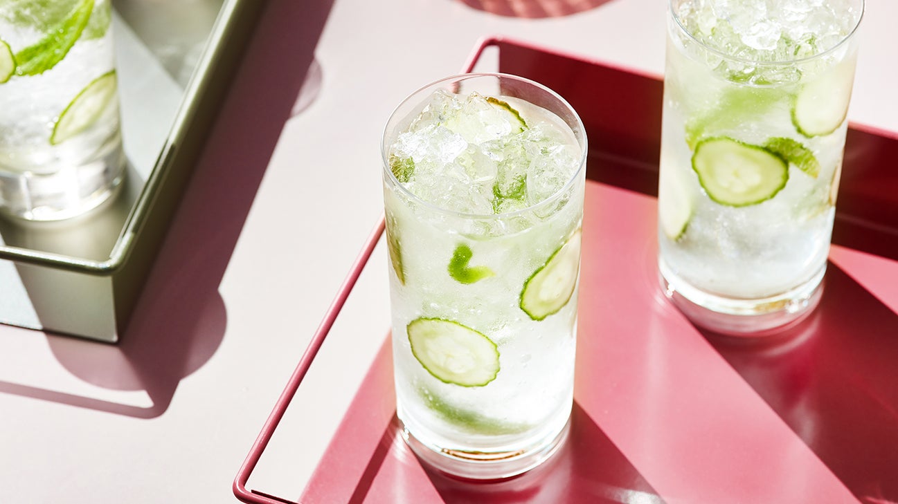 glass of cucumber water on pink tray
