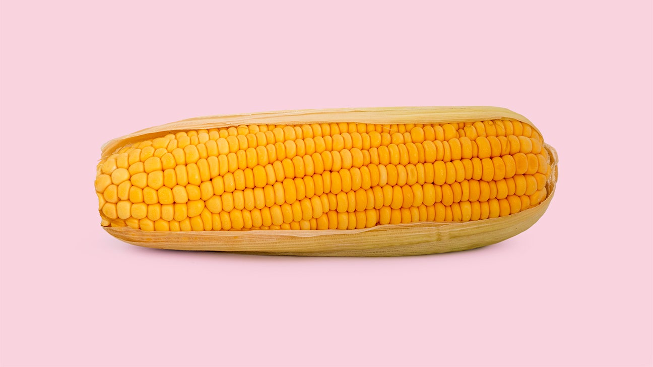 Corn on the cob on pink background