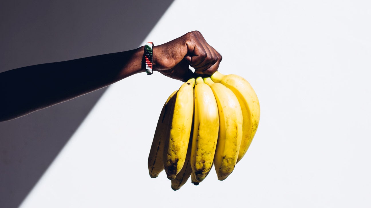 Hand holding a bunch of bananas 