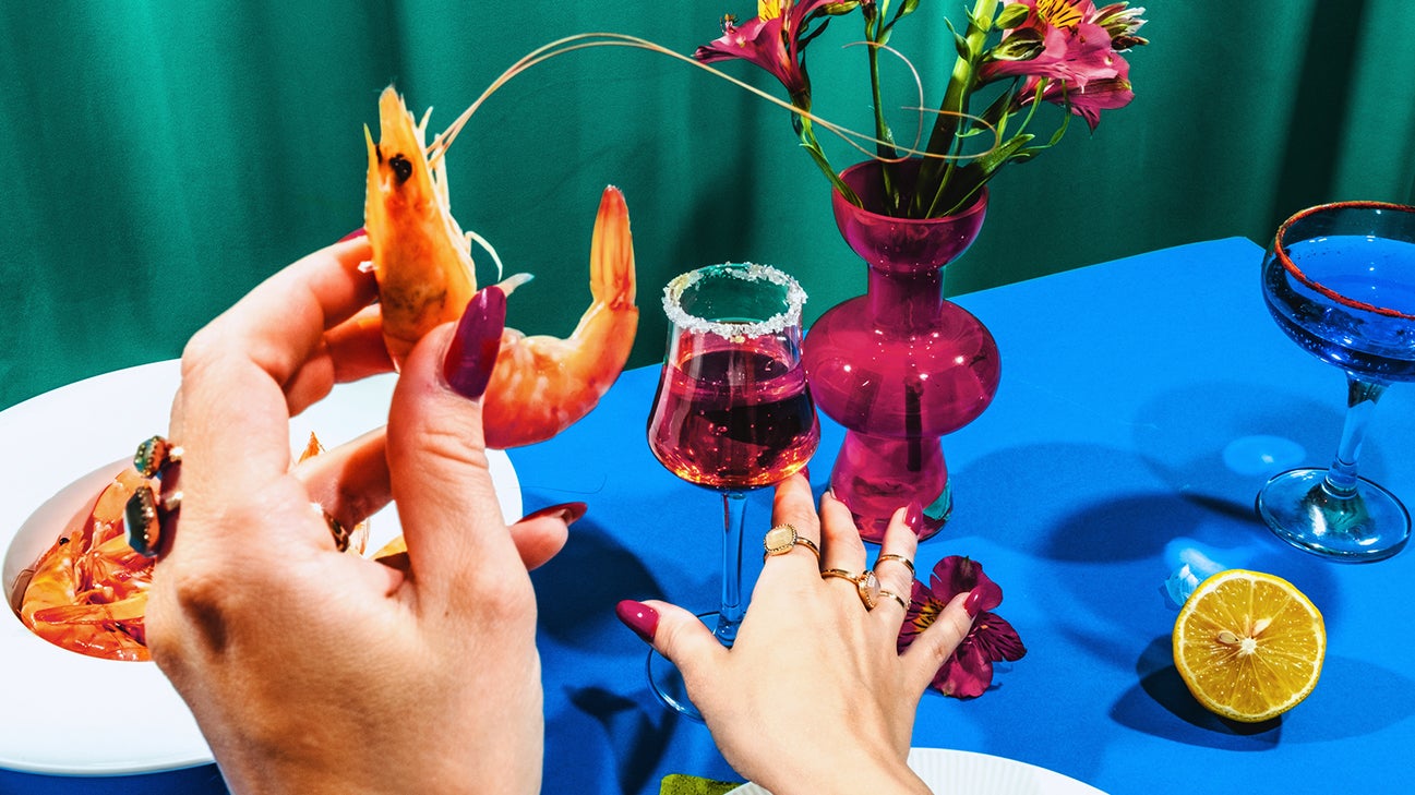 person holding a shrimp ready to eat