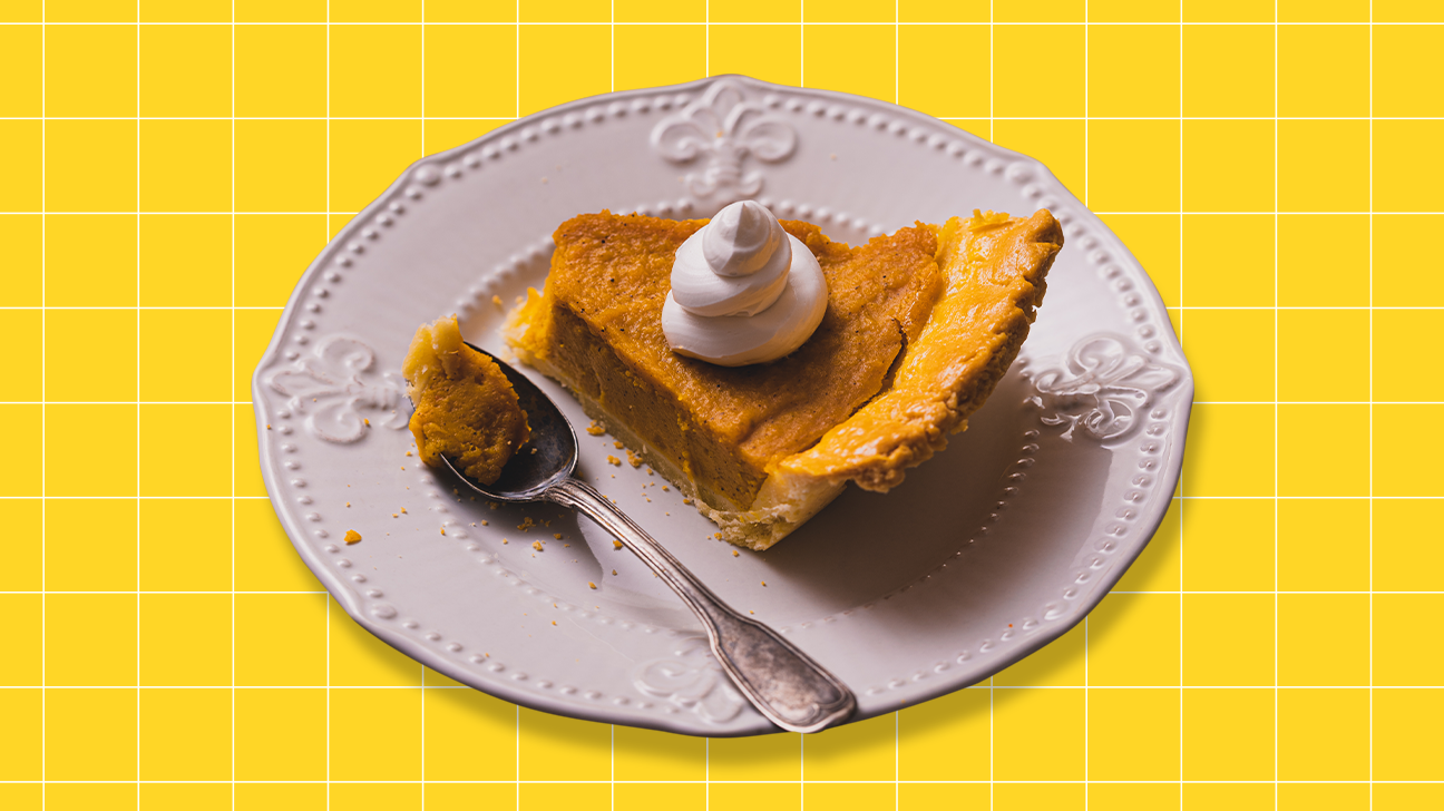 Piece of pumpkin pie on a white plate on a yellow background