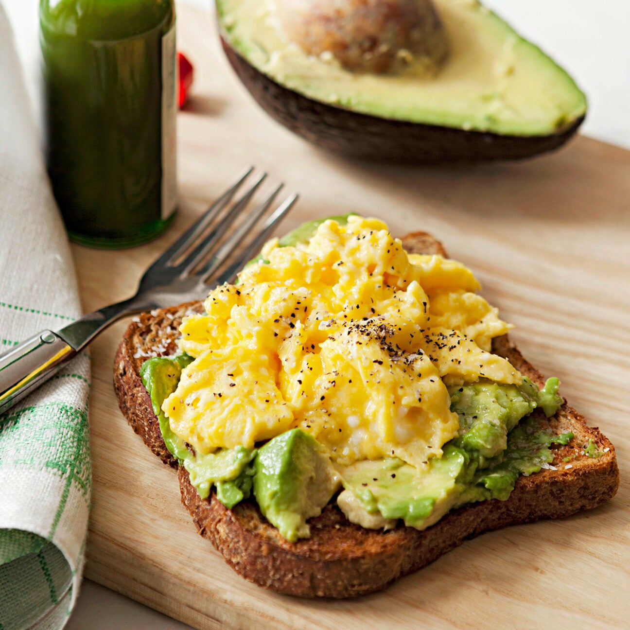 avocado toast topped with scrambled eggs