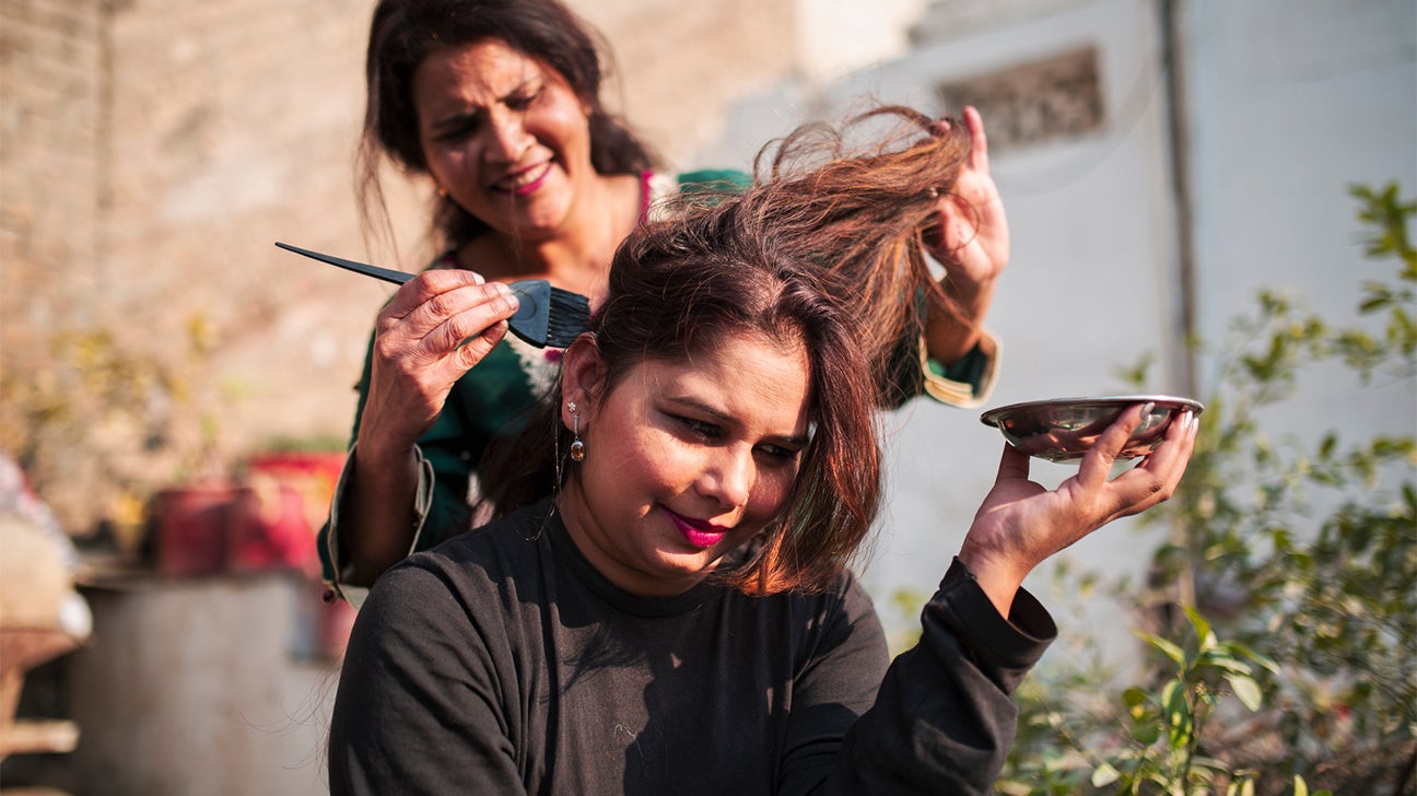 person applying henna to hair