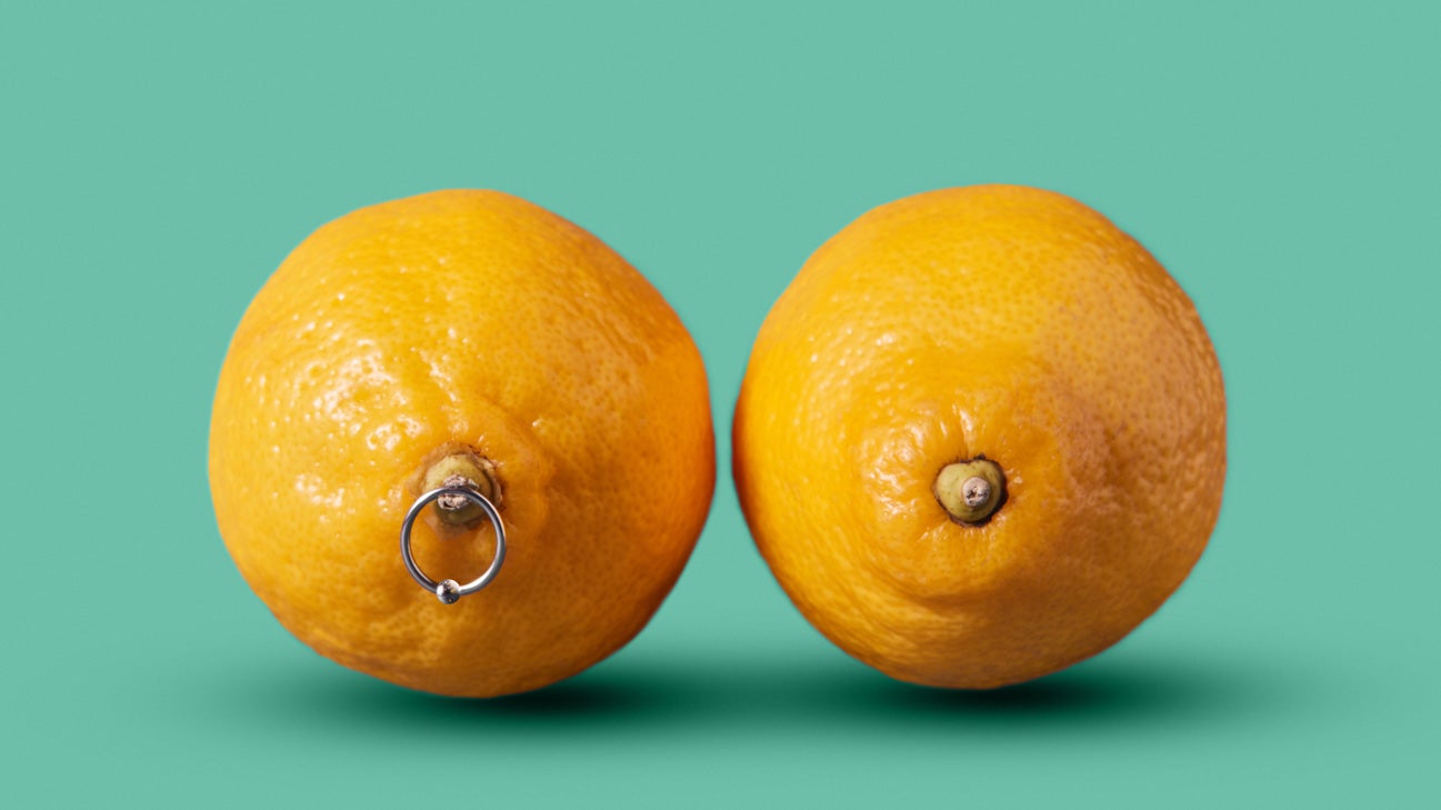 Orange representing breasts with nipple piercings