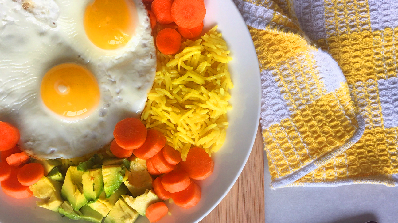 Golden rice with eggs, avocado, and carrots